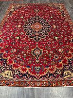 Full view of Persian Mashhad rug showing entire field and medallion