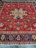 Full view of Persian Tabriz rug showing entire field and borders