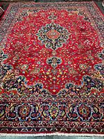 Full view of Persian rug showing field, medallion and borders