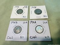 Four dated Canadian dimes in holders