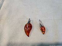 Pendant and single earring side by side