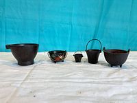 Front view of all five crucibles standing upright