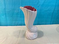 Front view of white swirl Beauceware vase with maroon interior