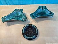 Top view showing two boomerang ashtrays and round Centennial ashtray