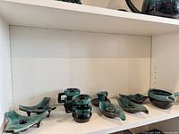 full shelf view of all nine Blue Mountain Pottery pieces