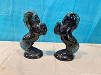 Front view of both rearing horse figurines