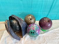 Group shot of four bowling balls and bag