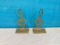 Front view of both brass treble clef bookends