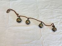 Full view of rope strand with four brass bells