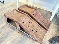 Top view of both metal ramps showing perforated tread and rust