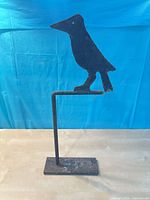 Front angle of cast iron bird silhouette on stand