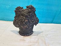 Front view showing floral cast iron door stop design