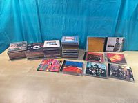 All 51 CDs stacked and spread out showing variety