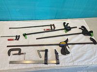 Full lot overview showing all six clamps laid out on table