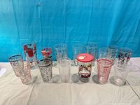 Front view of full set of printed cocktail glasses and lidded glass