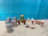 Overall group of canisters, syrup pitcher and assorted shakers