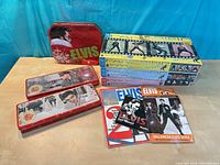 Overview of lot showing three tins, four boxed puzzles/games and magazines