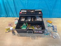 Overall view of tackle box and loose packaged tackle on table