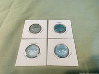 Four 1967 Canadian bobcat silver quarters in 2x2 holders