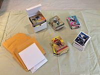Overall view of envelopes, card box and several stacks of hockey cards