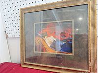 Full view of framed print showing frame style and glazing reflection