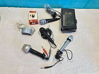 All microphones, voice changer unit, box and pouch laid out