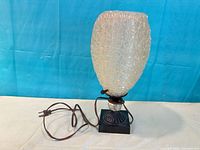 Front view of fiberglass spaghetti lamp with cord and base visible