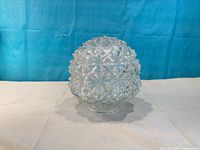 Side view of pressed glass globe lampshade showing starburst pattern