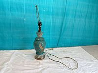 Full view of lamp front showing ceramic body, base, cord