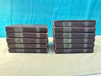 Two stacks of matching maroon hardcover encyclopedia volumes