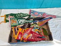 Box full of assorted vintage felt pennants