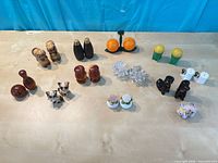 Overview of all eleven salt and pepper shaker pairs on table