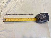 Bracelet beside tape measure showing length around 8 in