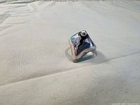 Front view of silver ring showing lightning bolt cut-out and bead accent