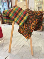 Both tablecloths draped to show overall colours and patterns