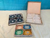 All three boxed sets of ashtrays displayed
