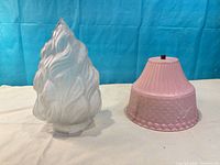 Both lampshades upright: white flame-form and pink tapered shade