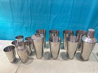 Front view showing two complete cobbler shakers and ten mixing cups