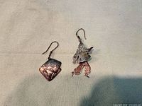 Both earrings side by side showing designs and hooks