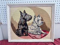 Full view of framed needlepoint showing two terriers