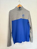 Front view showing color blocking, zipper, chest emblem