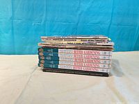 Stack of all ten books and magazines side view