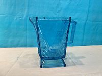 Side view showing handle, spout, pattern and overall condition