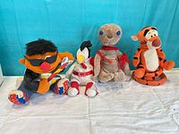 Front view of the four plush toys arranged side by side