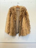 Front view of brown-tan fur coat with lining visible