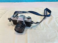 Front angled view of Yashica FR camera with attached 50mm lens and Sony strap visible