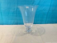 Full view of clear glass pedestal vase