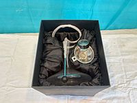 Decanter set arranged inside black satin-lined box