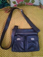 Front view showing purse, strap, pockets, hardware