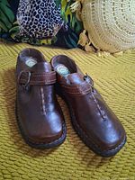 Top view showing pair of brown leather clogs